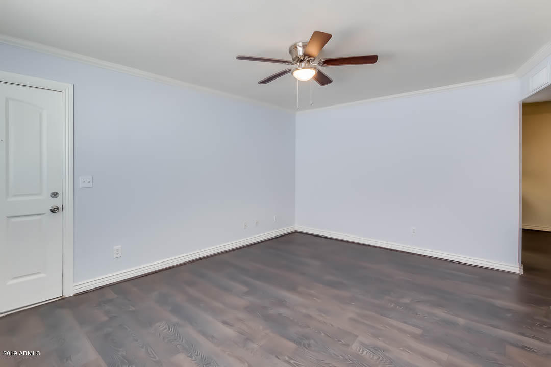 1860 East Inverness Avenue Mesa, AZ 85204 - Photo 8 of 29 a view of a small space with wooden floor and a ceiling fan