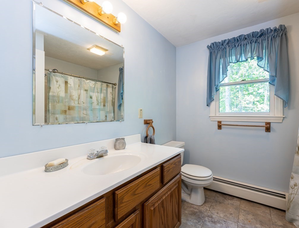 105 Warren Road Townsend, MA 01469 - Photo 17 of 37 a bathroom with a sink toilet and a window