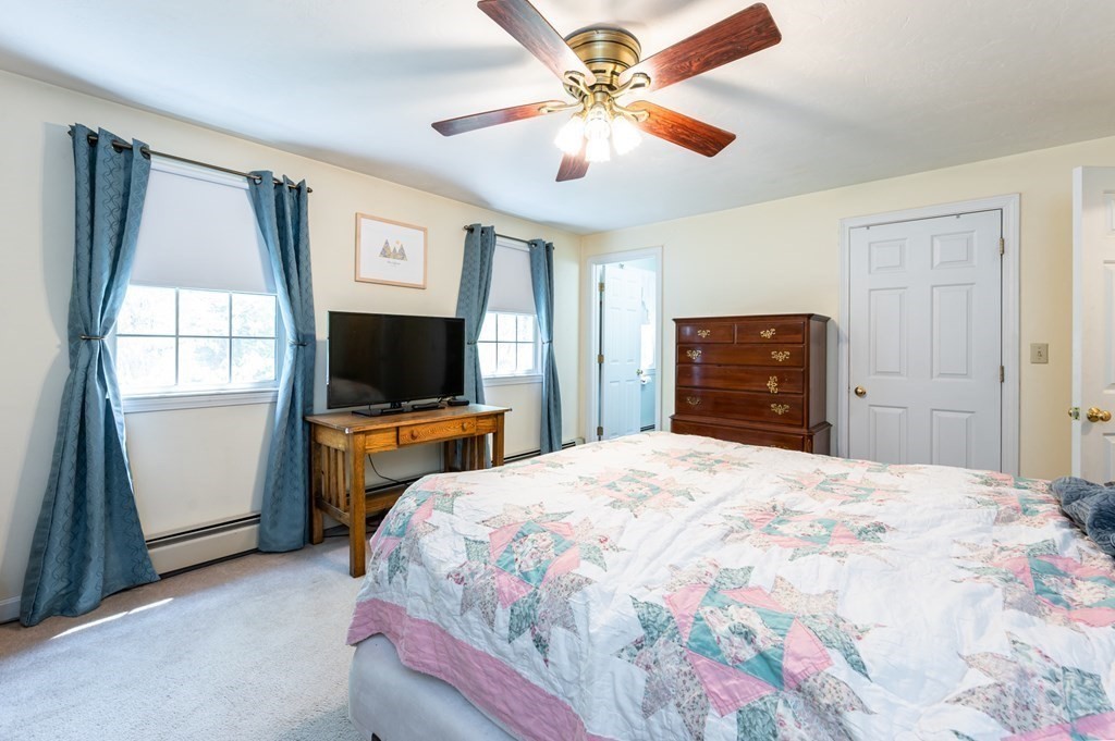 105 Warren Road Townsend, MA 01469 - Photo 19 of 37 a bedroom with a bed and a flat screen tv