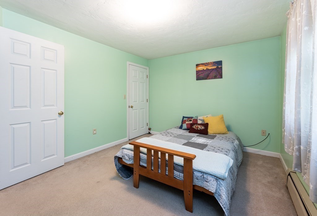 105 Warren Road Townsend, MA 01469 - Photo 23 of 37 a bedroom with a bed and a table