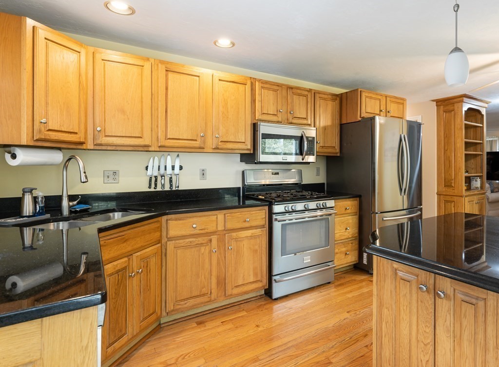 105 Warren Road Townsend, MA 01469 - Photo 6 of 37 a kitchen with stainless steel appliances a refrigerator sink and cabinets