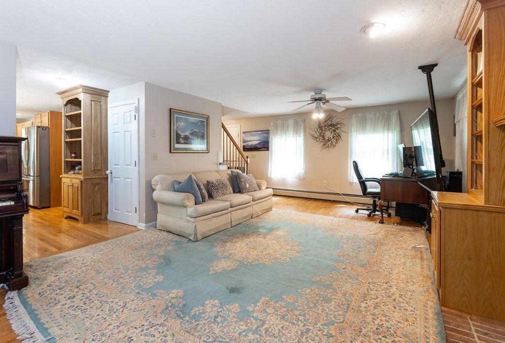 105 Warren Road Townsend, MA 01469 - Photo 10 of 37 a living room with furniture and a flat screen tv