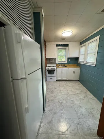 a kitchen with a refrigerator and a sink