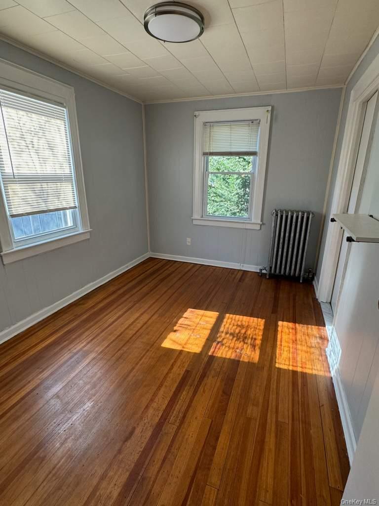 12 Forest Row Great Neck, NY 11023 - Photo 2 of 4 wooden floor in a room next to a window