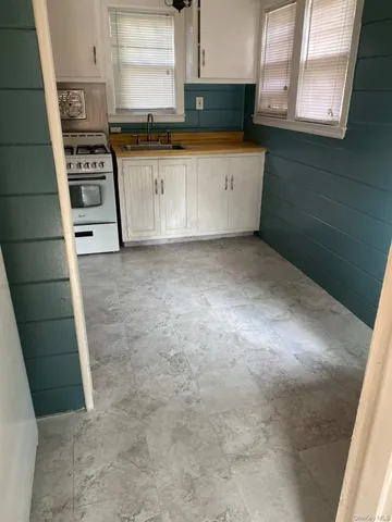 a view of kitchen with microwave and cabinets