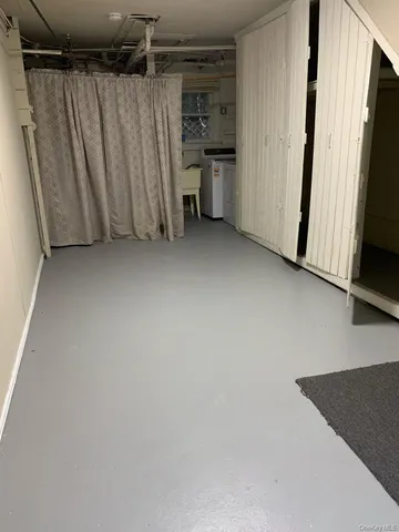 a view of a storage & utility room with a refrigerator