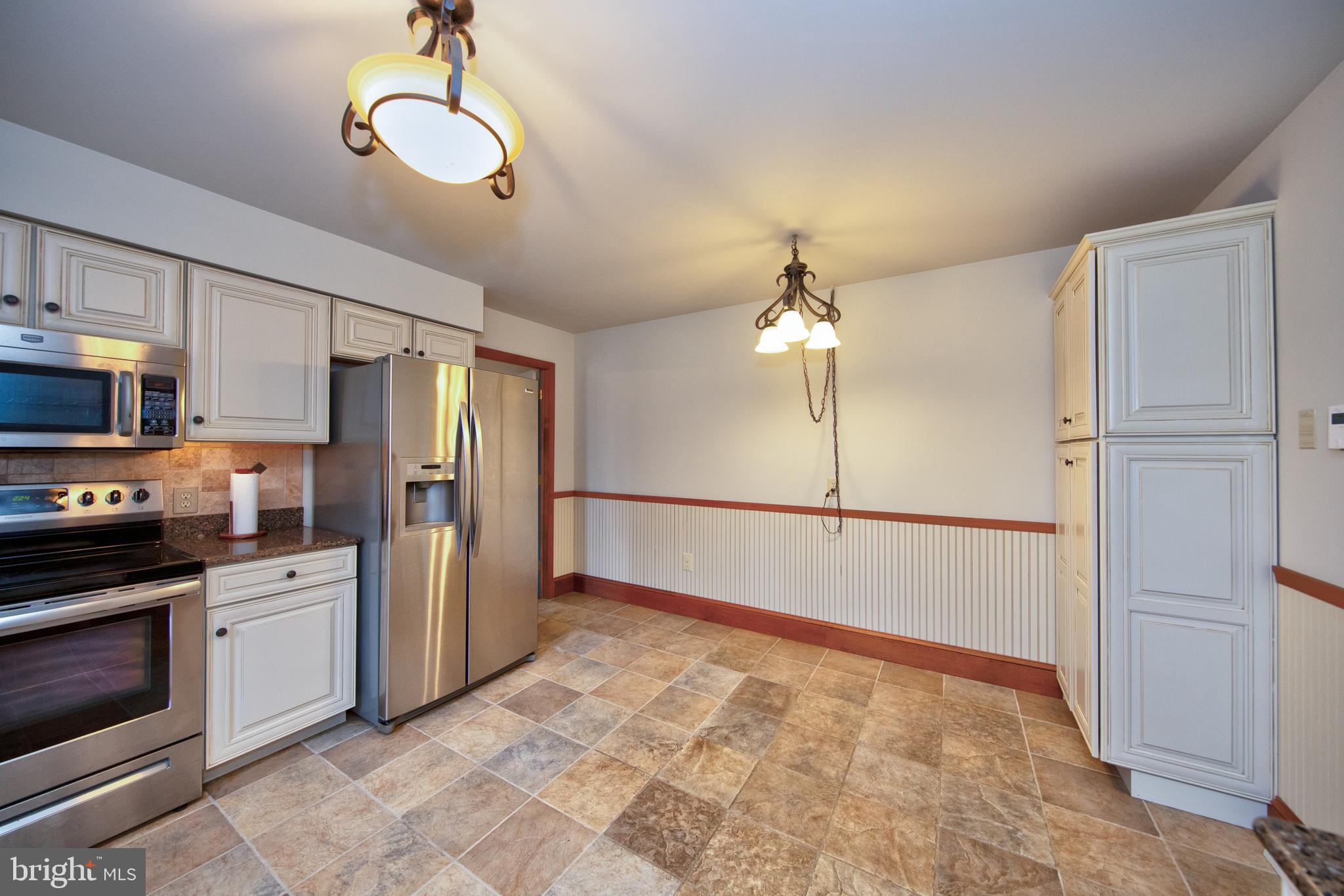 3044 Level Road Churchville, MD 21028 - Photo 15 of 52 a view of a kitchen with a stove cabinets and wooden floor