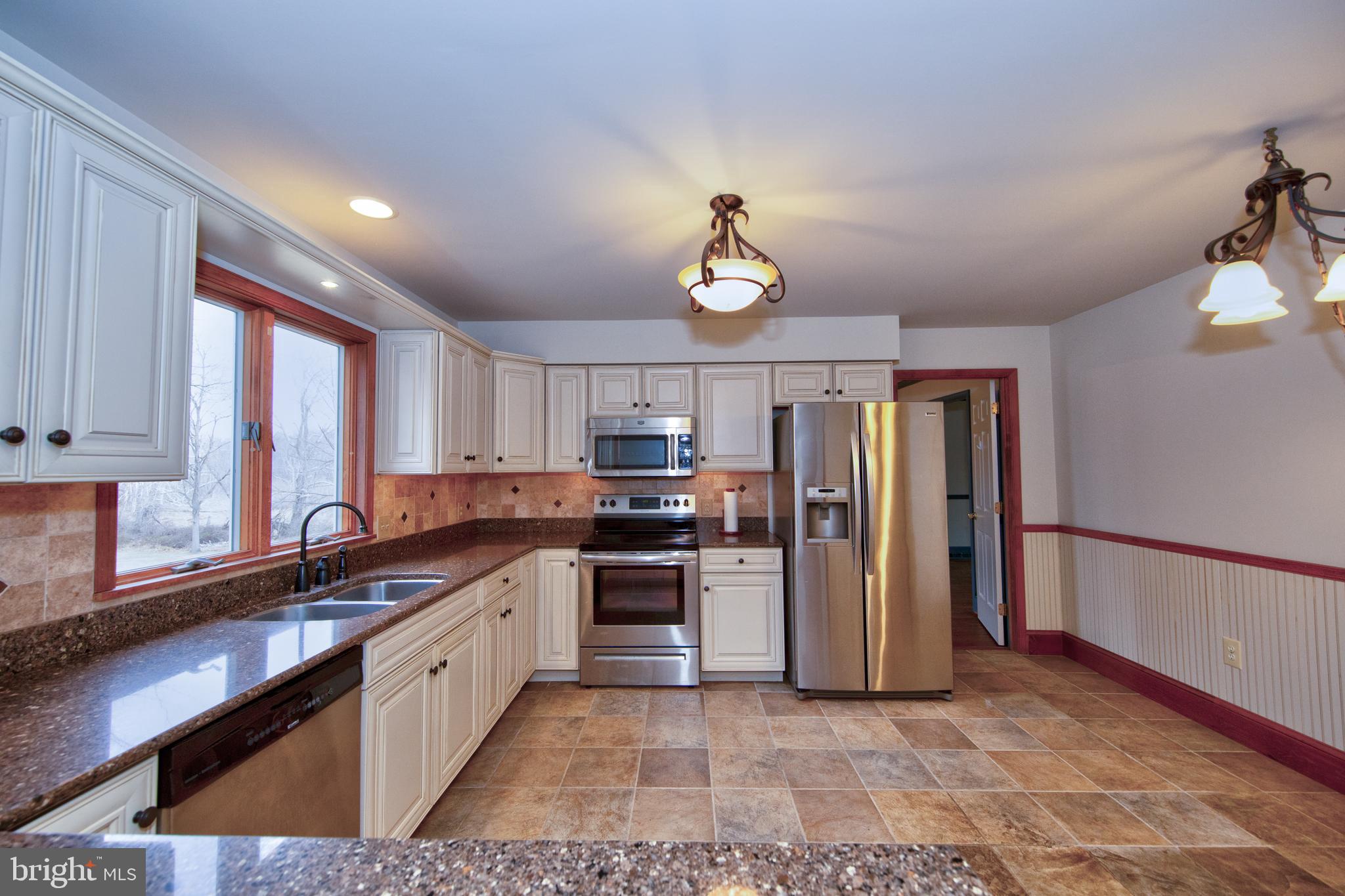 3044 Level Road Churchville, MD 21028 - Photo 16 of 52 a kitchen with stainless steel appliances granite countertop a sink a stove and refrigerator