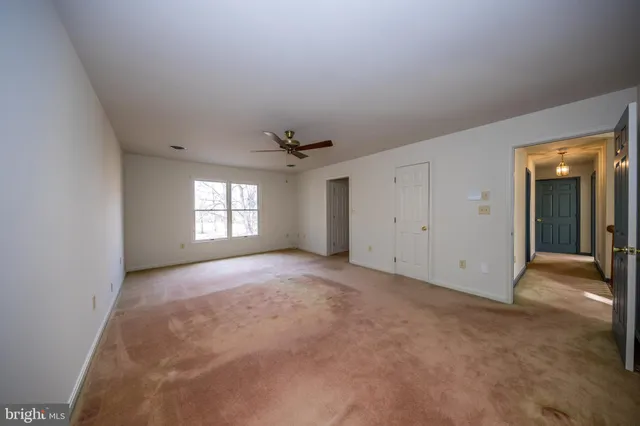 an empty room with windows and entrance