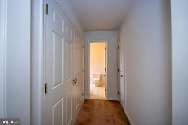 a view of a hallway with wooden floor and a hallway