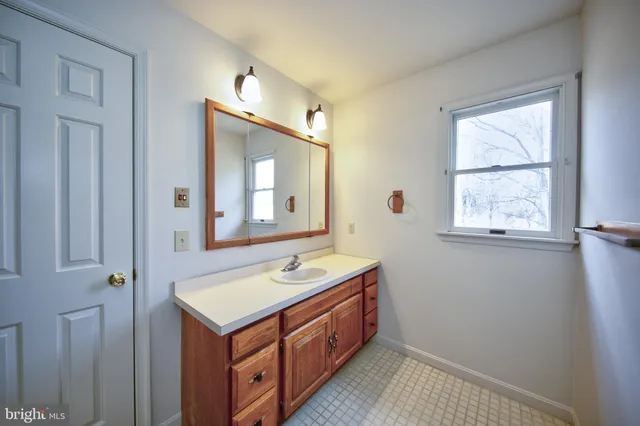 a bathroom with a sink a vanity and a mirror