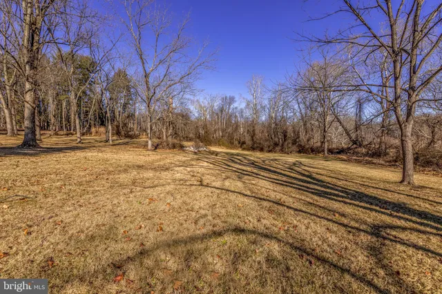 a view of yard covered with snow in front of house