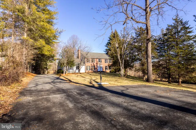 a view of a house with snow on the road