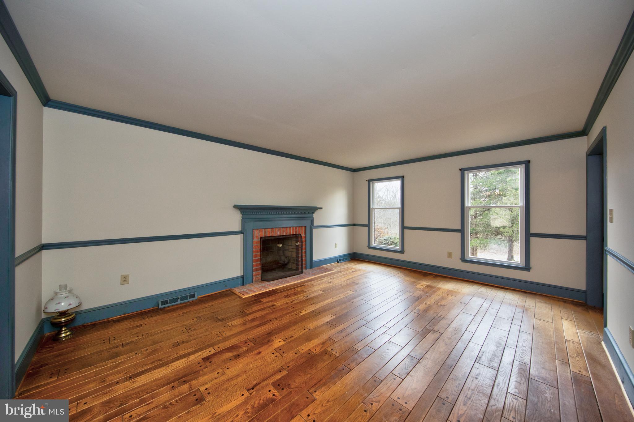 3044 Level Road Churchville, MD 21028 - Photo 9 of 52 a view of empty room with wooden floor and fireplace