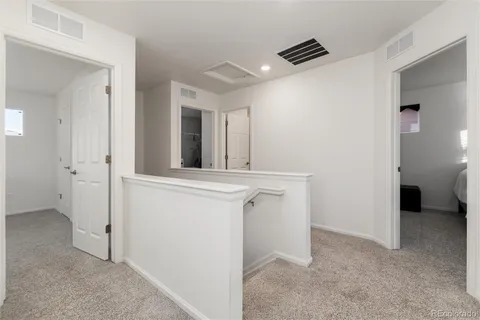 a view of a brick house with many windows next to a yard