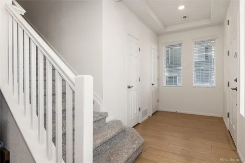 a view of entryway and hall with a couch