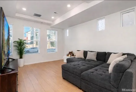 a kitchen with stainless steel appliances a refrigerator a stove a sink a dining table and chairs