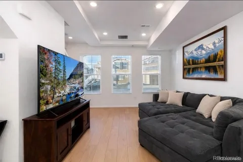 a kitchen with a sink a stove a refrigerator and white cabinets