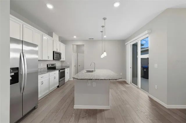 a kitchen with a refrigerator and a sink