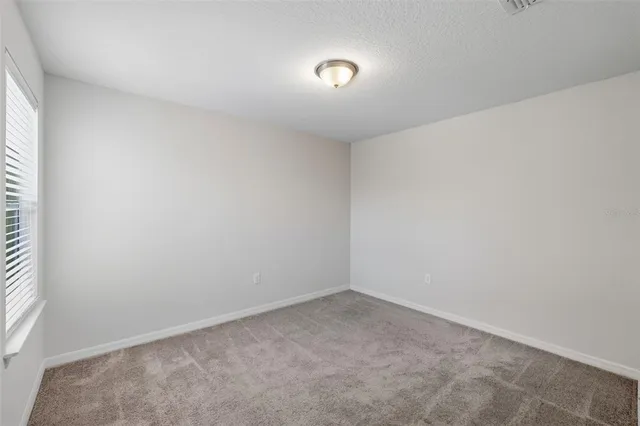 an empty room with a empty space and windows