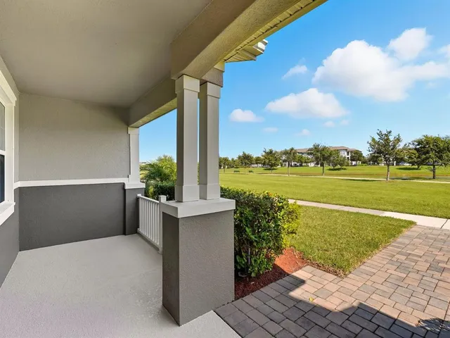 a terrace with a garden and lake view