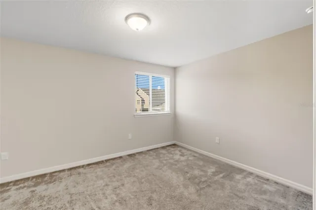 an empty room with a empty space and window