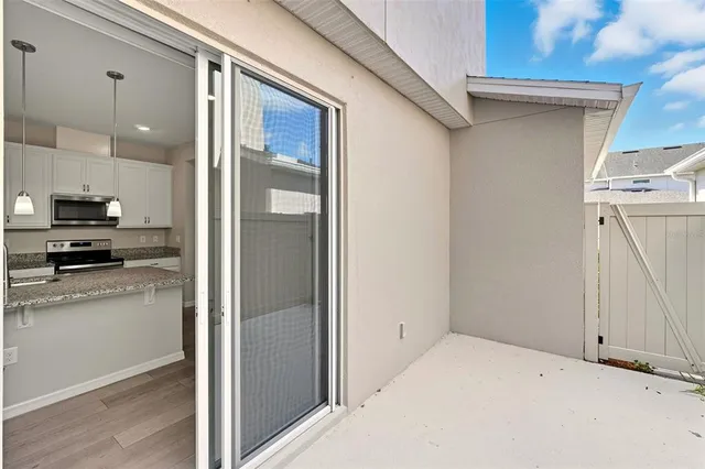 a view of a kitchen with a refrigerator a stove top oven and cabinets