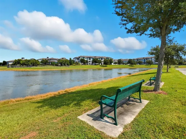 a swimming pool with outdoor seating and garden