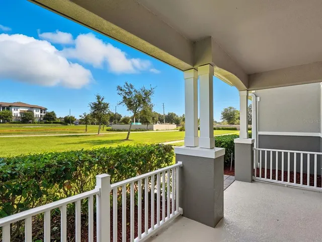 a view of a balcony with floor to ceiling windows