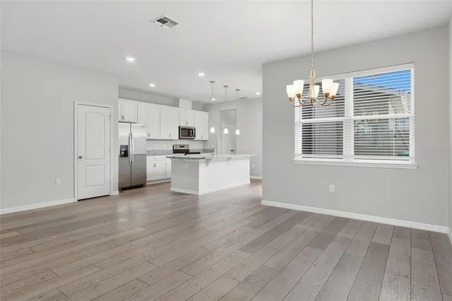 a view of kitchen with wooden floor and window