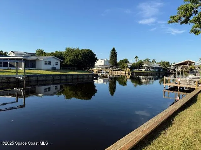 a view of a lake with couches chairs
