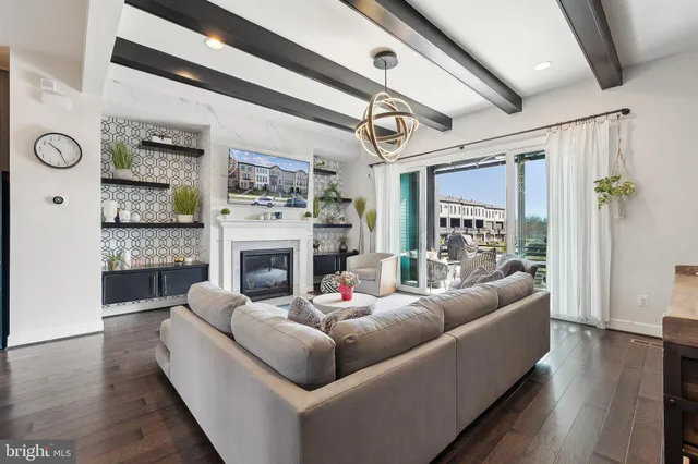 a living room with fireplace furniture and a potted plant
