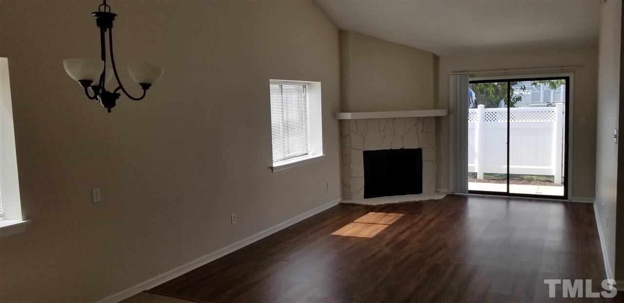 5001 Casa Del Rey Drive Raleigh, NC 27616 - Photo 2 of 7 a view of empty room with wooden floor and fireplace