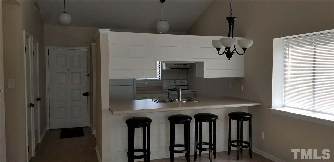 5001 Casa Del Rey Drive Raleigh, NC 27616 - Photo 3 of 7 a kitchen with a table and chairs in it