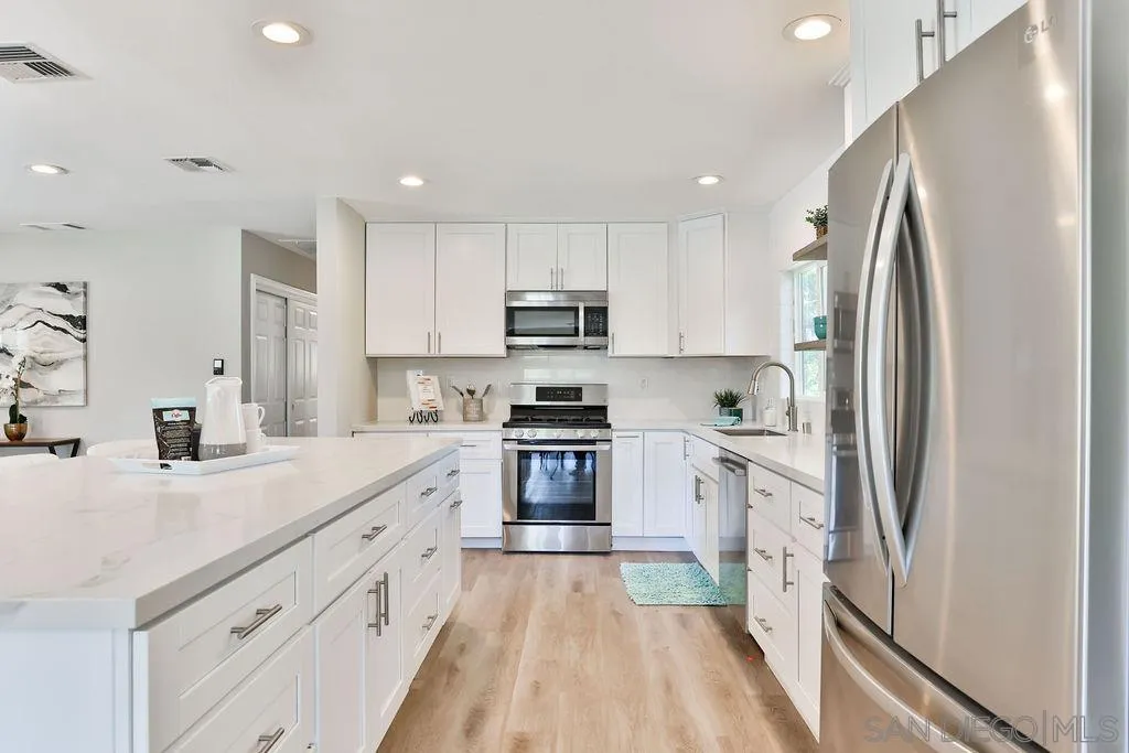 9802 Sierra Madre Road Spring Valley, CA 91977 - Photo 12 of 48 a kitchen with stainless steel appliances granite countertop a refrigerator sink and stove