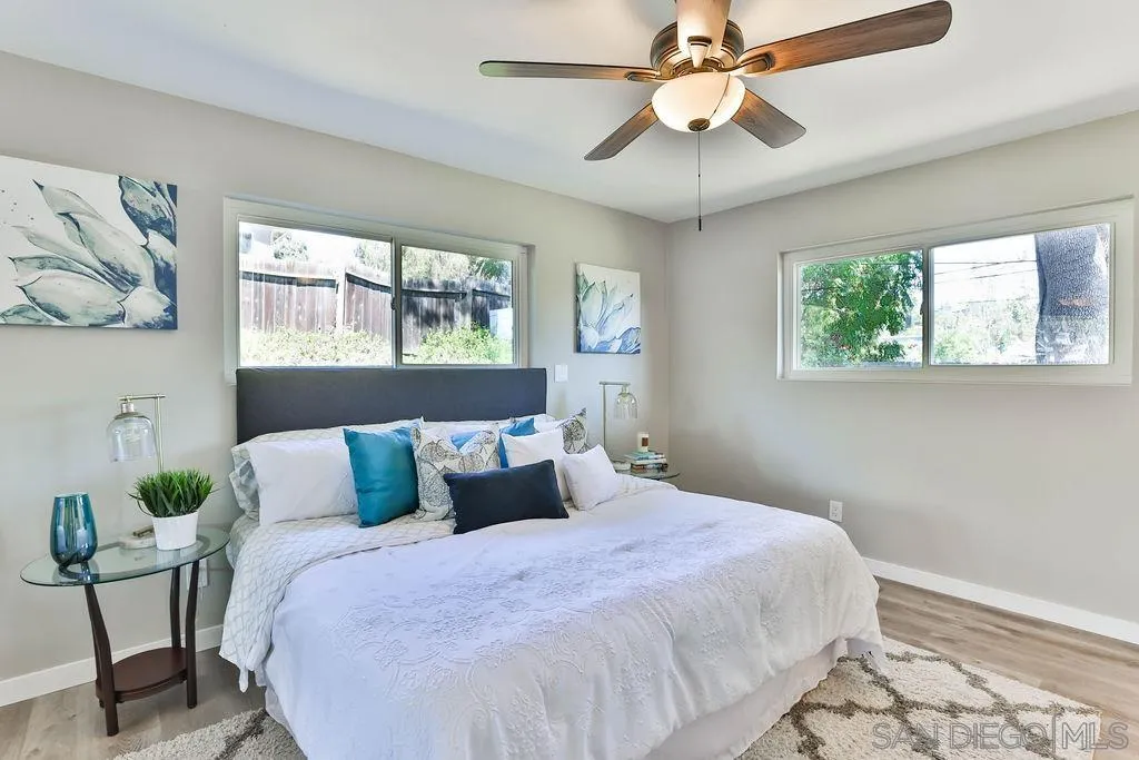 9802 Sierra Madre Road Spring Valley, CA 91977 - Photo 19 of 48 a bedroom with a bed and a chandelier