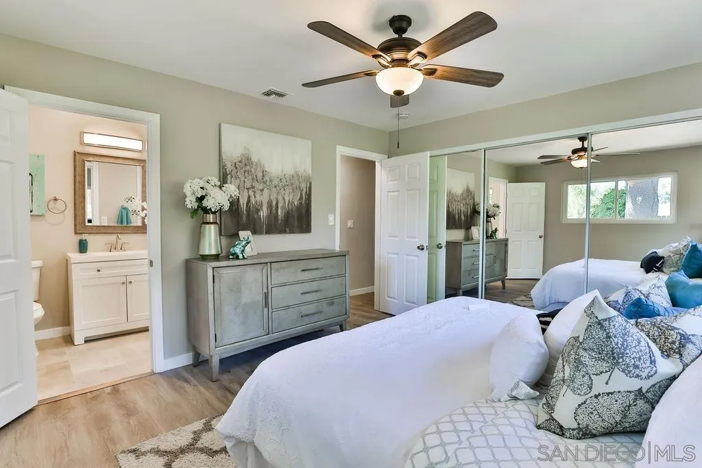 9802 Sierra Madre Road Spring Valley, CA 91977 - Photo 21 of 48 a bedroom with a large bed and a chandelier fan