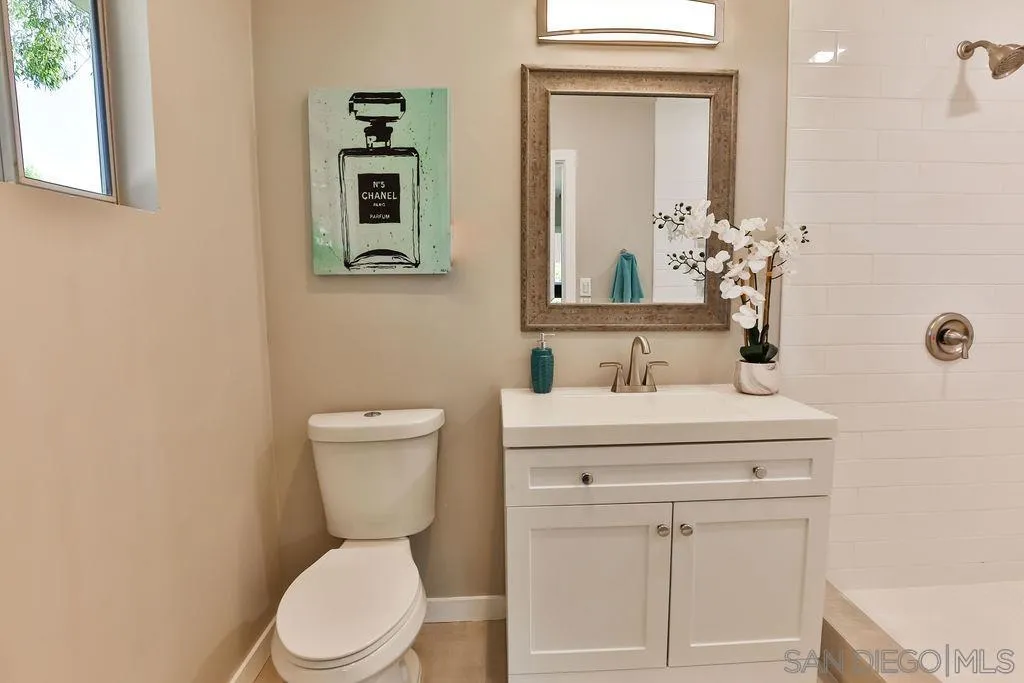 9802 Sierra Madre Road Spring Valley, CA 91977 - Photo 22 of 48 a bathroom with a toilet a sink and mirror
