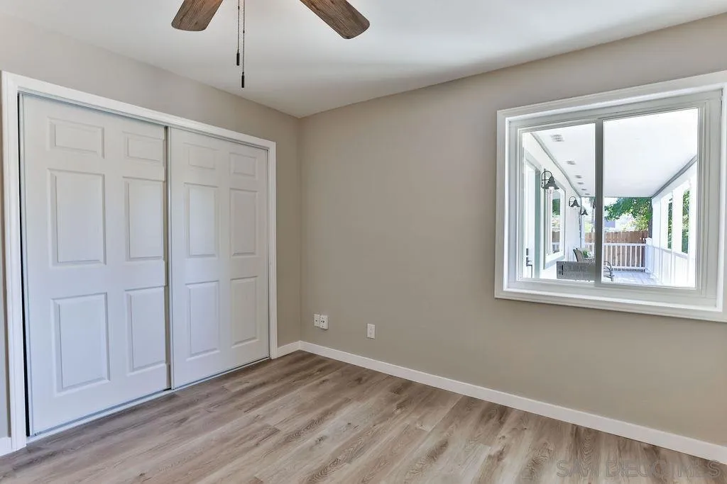 9802 Sierra Madre Road Spring Valley, CA 91977 - Photo 25 of 48 a view of an empty room with a window and wooden floor