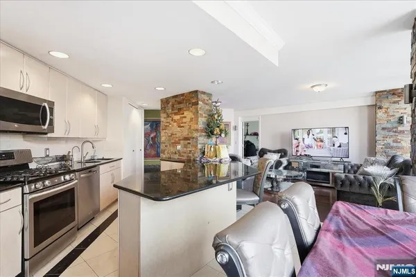 a view of a living room kitchen and a stove