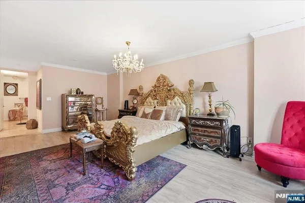 a bed room with furniture and a chandelier