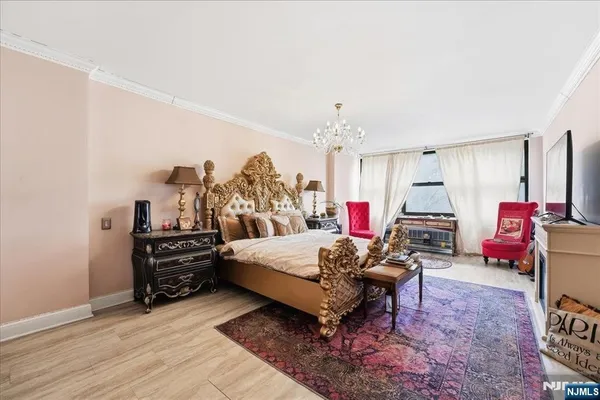 a bedroom with furniture and a chandelier