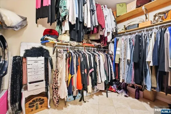 a view of walk in closet with clothes