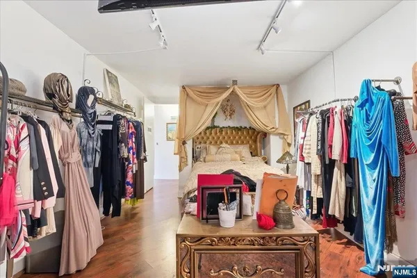 a view of walk in closet with clothes