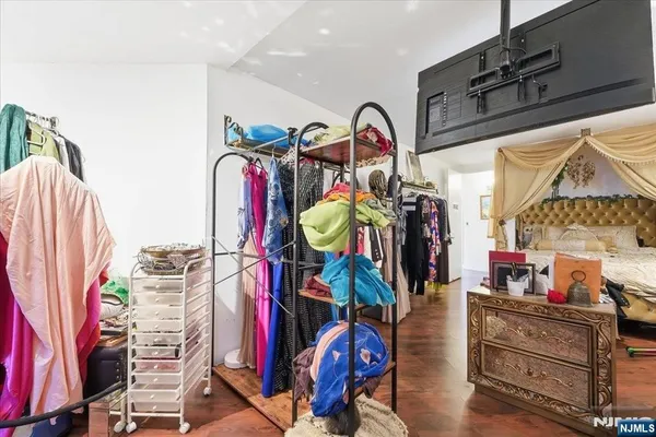 a view of walk in closet with clothes