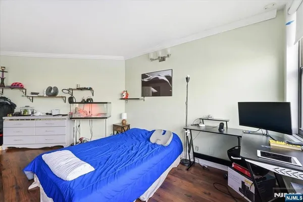a bed room with a bed and a flat screen tv