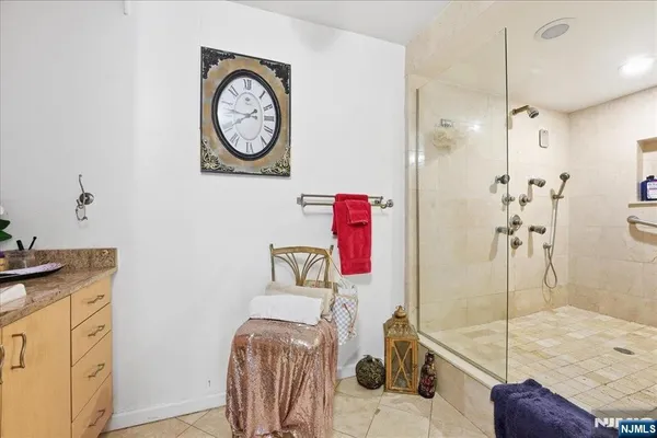 a bathroom with a granite countertop sink a toilet and a shower