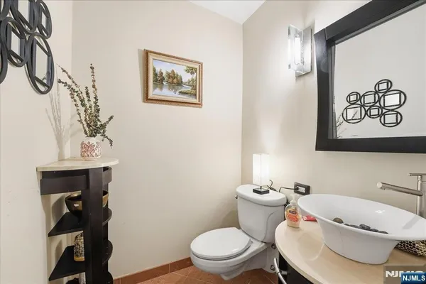 a white toilet sitting next to a bathroom sink