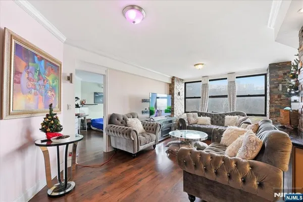 a living room with furniture and flowers