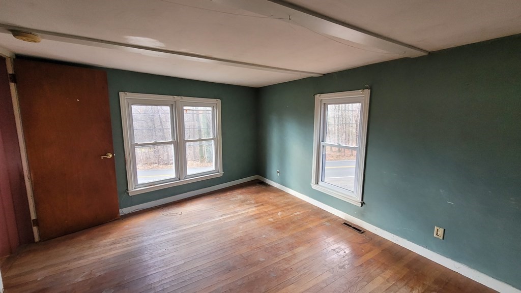 136 Main Road Westfield, MA 01085 - Photo 7 of 13 an empty room with wooden floor and windows